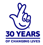National lottery logo of hand with fingers crossed. Words underneath say 30 years of changing lives.